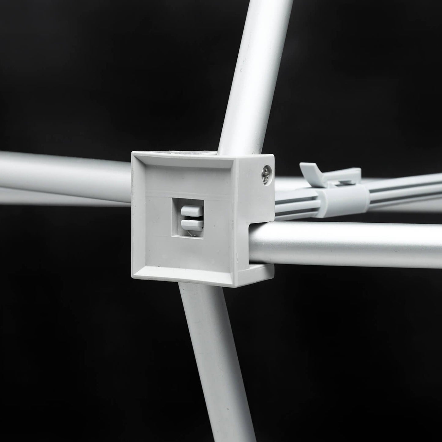 Close-up of a white metal bracket on a black background